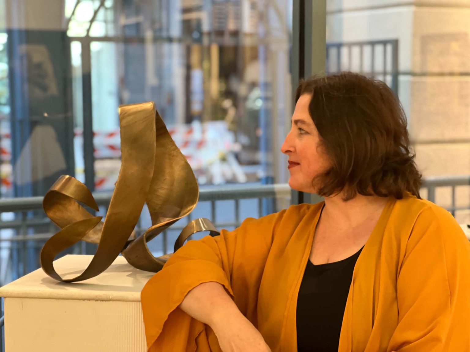 Natalia Koren beside a sculptural work